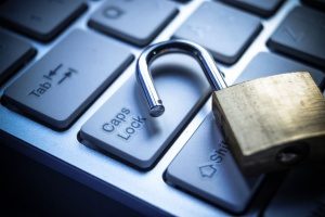 a padlock on a keyboard representing cyber liability insurance