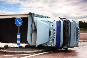 overturned semi truck carrying equipment covered by staging and rigging insurance