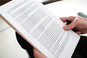 Business owner reading over details of his cannabis loss of income insurance policy