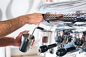 espresso being made from a coffee machine that frequently breaks down so the business will contact an entertainment insurance agency to discuss purchasing a policy