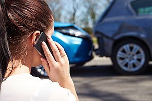 woman on the phone with her entertainment insurance broker since she was in a group travel accident with her fellow film production crew members