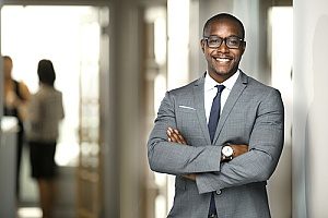 a drone insurance broker who is smiling and is ready to meet with a person who owns multiple drones