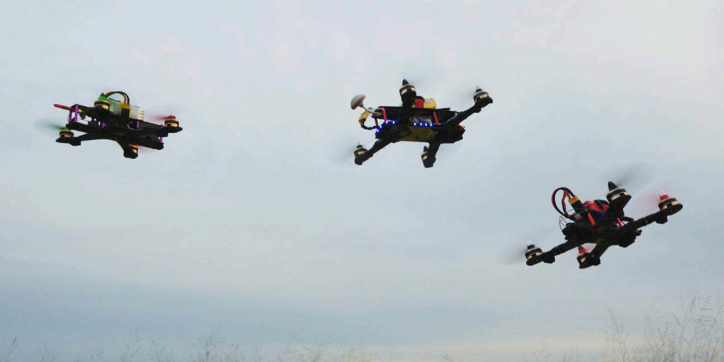 drones flying next to each other during a race that is covered by drone insurance for liability protection during the event