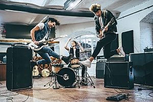 a rock band practicing for an upcoming tour and discussing insurance for bands