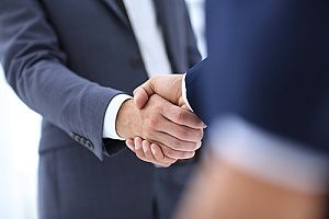 special event insurance broker shaking hands with a music festival company owner