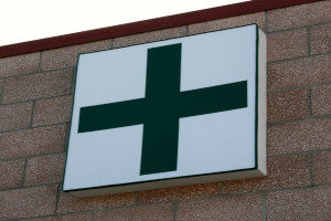 Medicinal marijuana dispensary with a green cross on the storefront