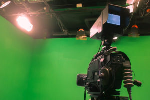 a professional camera and a green screen on the set of a short term film covered by insurance