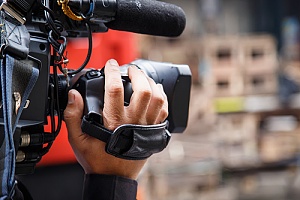 person holding a camera filming
