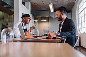 insurance broker discussing the benefits of assault & battery insurance for restaurants