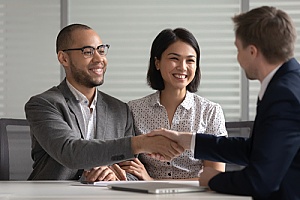 an engaged couple that is speaking to a wedding insurance broker
