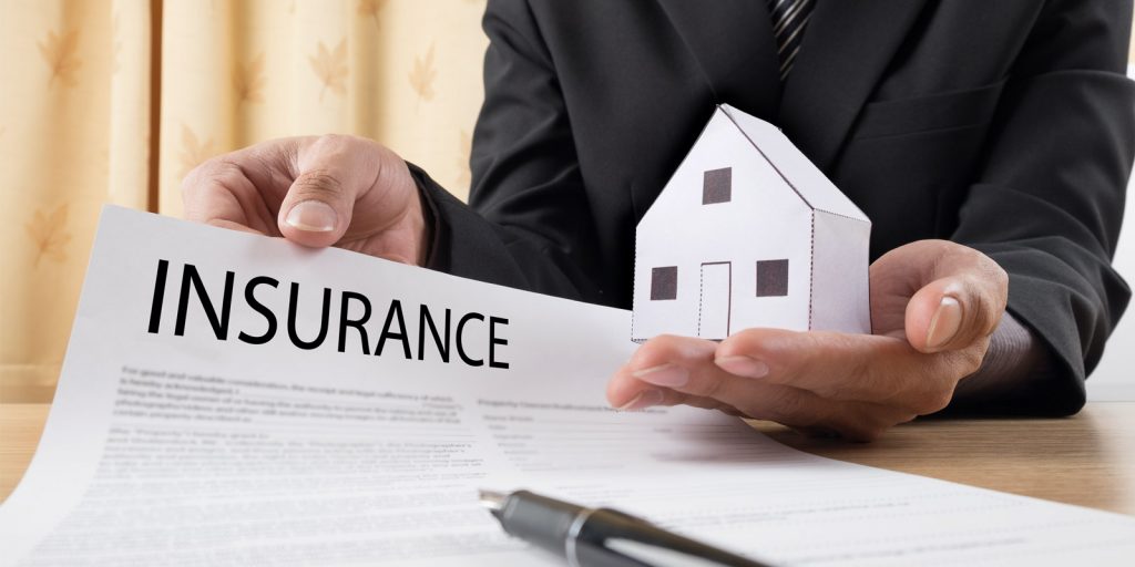 an insurance broker giving a personal liability insurance application to a homeowner