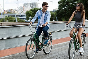a young couple riding rental bikes in the city