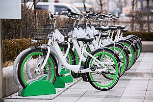 app rental bikes lined up in a city