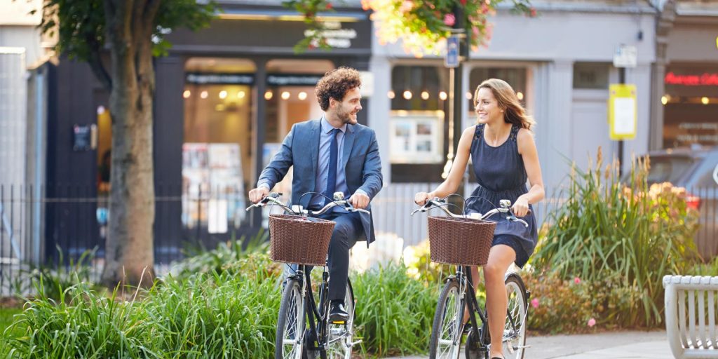 business individuals riding bikes in the city representing micromobility