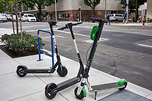 scooters on the side of the road in a city