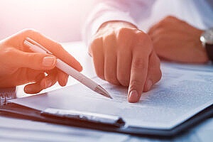 an insurance broker reviewing directors and officers insurance with the owner of an entertainment company