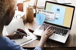 women looking on her laptop covered by cyber liability insurance