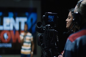 medium shot of the cameraman shoots a young talent with film production insurance