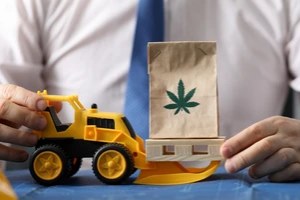 man holding cannabis bag and toy truck with Cannabis Cargo Insurance