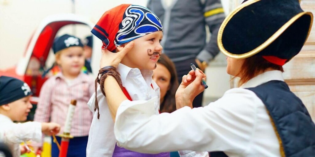 woman painting kids face on an event