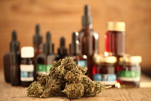 different cannabis products displayed on a wooden table