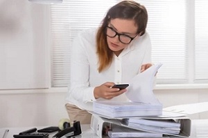 female employee taking photos of secret document