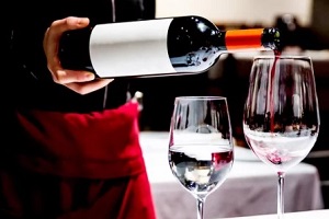 waiter pouring wine in glass