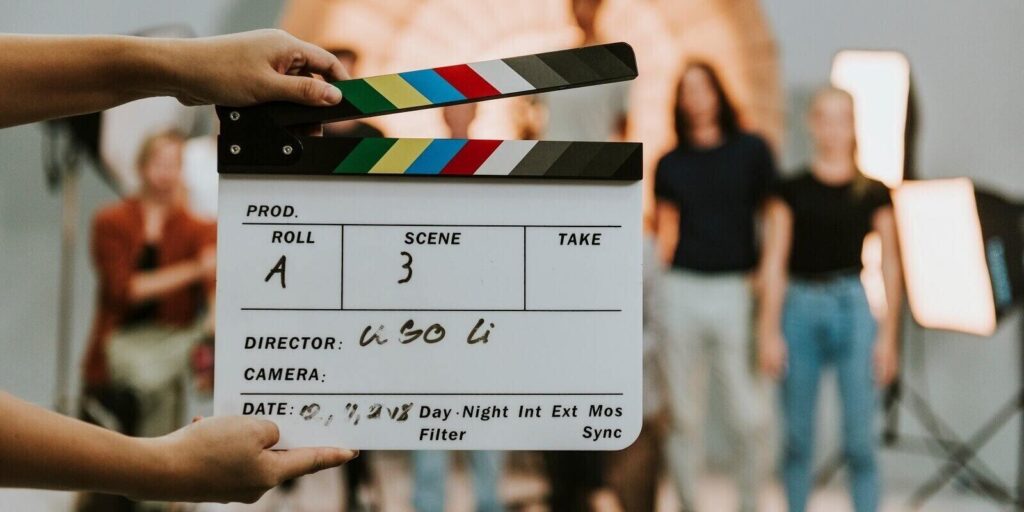 woman holding a movie production clapperboard