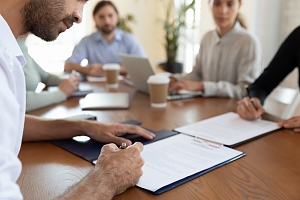 a business man signing documentation for a license