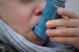 child using an inhaler with medical marijuana prescribed by a doctor