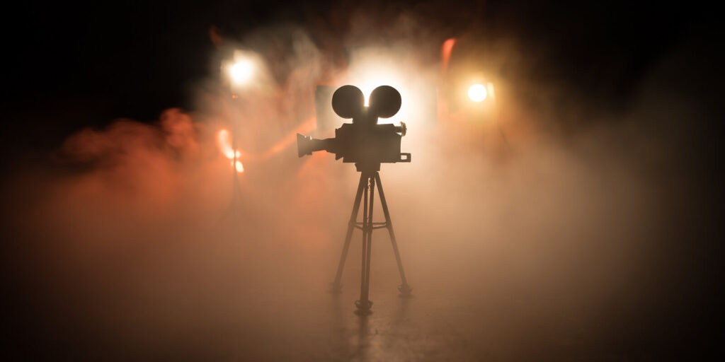 miniature movie set on dark toned background with fog and empty space