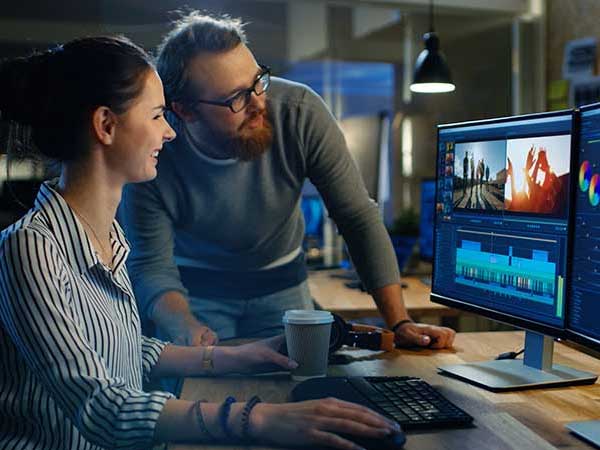 Film production editors viewing taped footage on computer