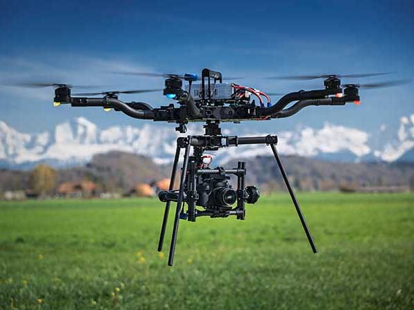 Filming drone in pasture that is covered by a drone insurance policy