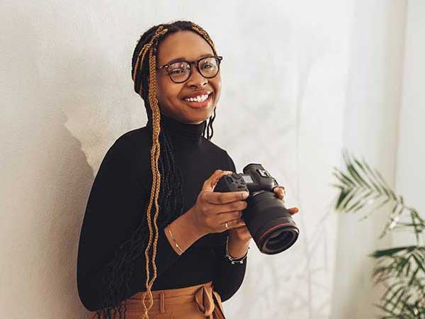 Happy photographer who is protected by a photographer insurance policy