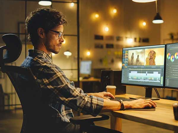 Man editing the latest footage he took during a production