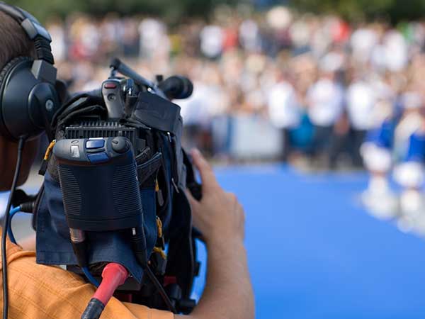 Videographer shooting documentary footage