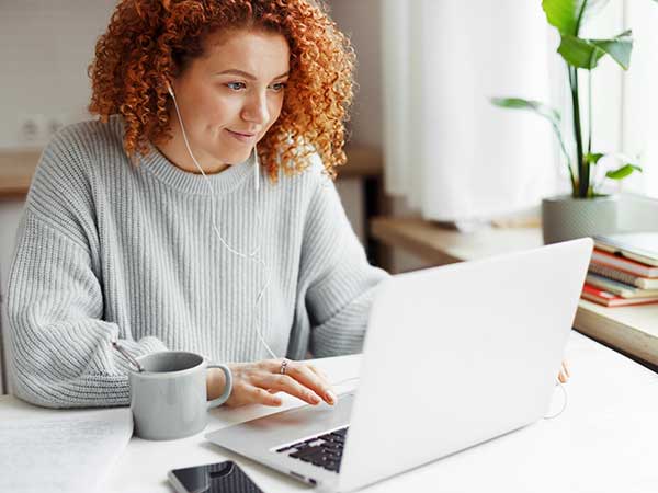 Woman on laptop submitting application for production insurance