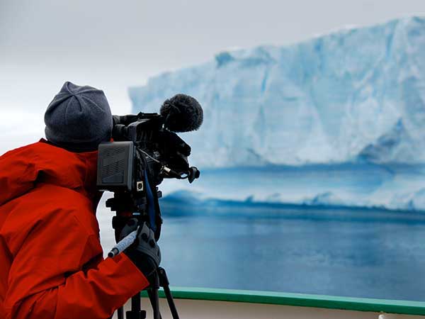 Woman shooting footage for a documentary about the arctic