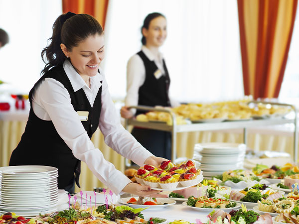 catering service placing food on table