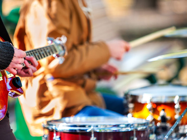closeup view of guitar and percussion player at a festival