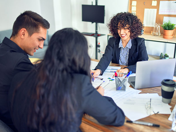 woman and couple talking in an office