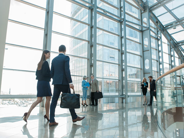 Business owners walking in building covered by an umbrella insurance policy