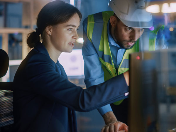 Employees reviewing their current inventory on the computer