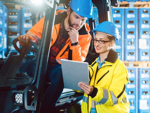 Employees reviewing their orders for the day on clipboard