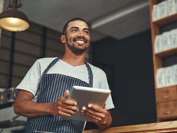 Entrepreneur smiling at his employees