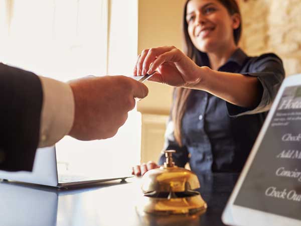 Hotel concierge taking credit card from guest