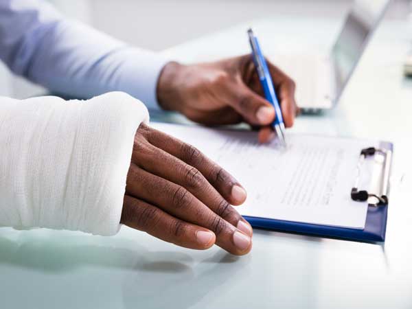 Injured person signing a document