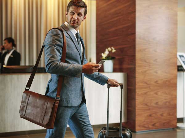 Man checking into a hotel covered by hospitality general liability insurance