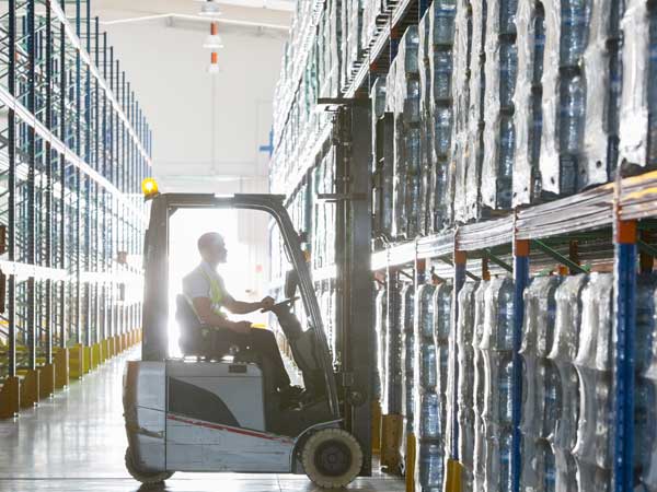 Man loading up jugs of water