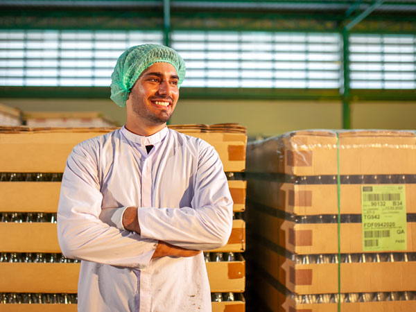 Man smiling after acquiring business insurance for consumer packaged goods organizations